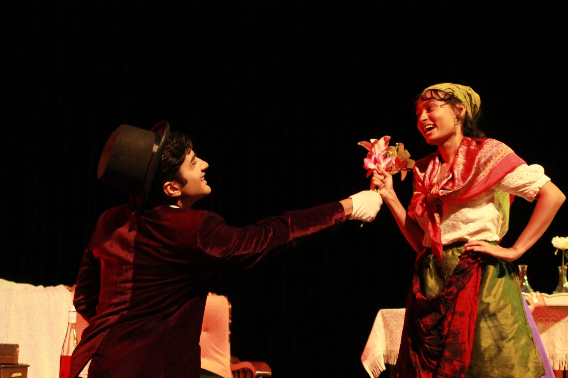 Scene from The Proposal: the suitor offers flowers to a young woman