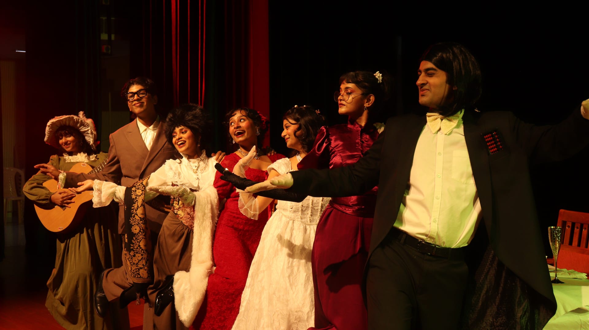Scene from The Wedding: guests sing to a guitar