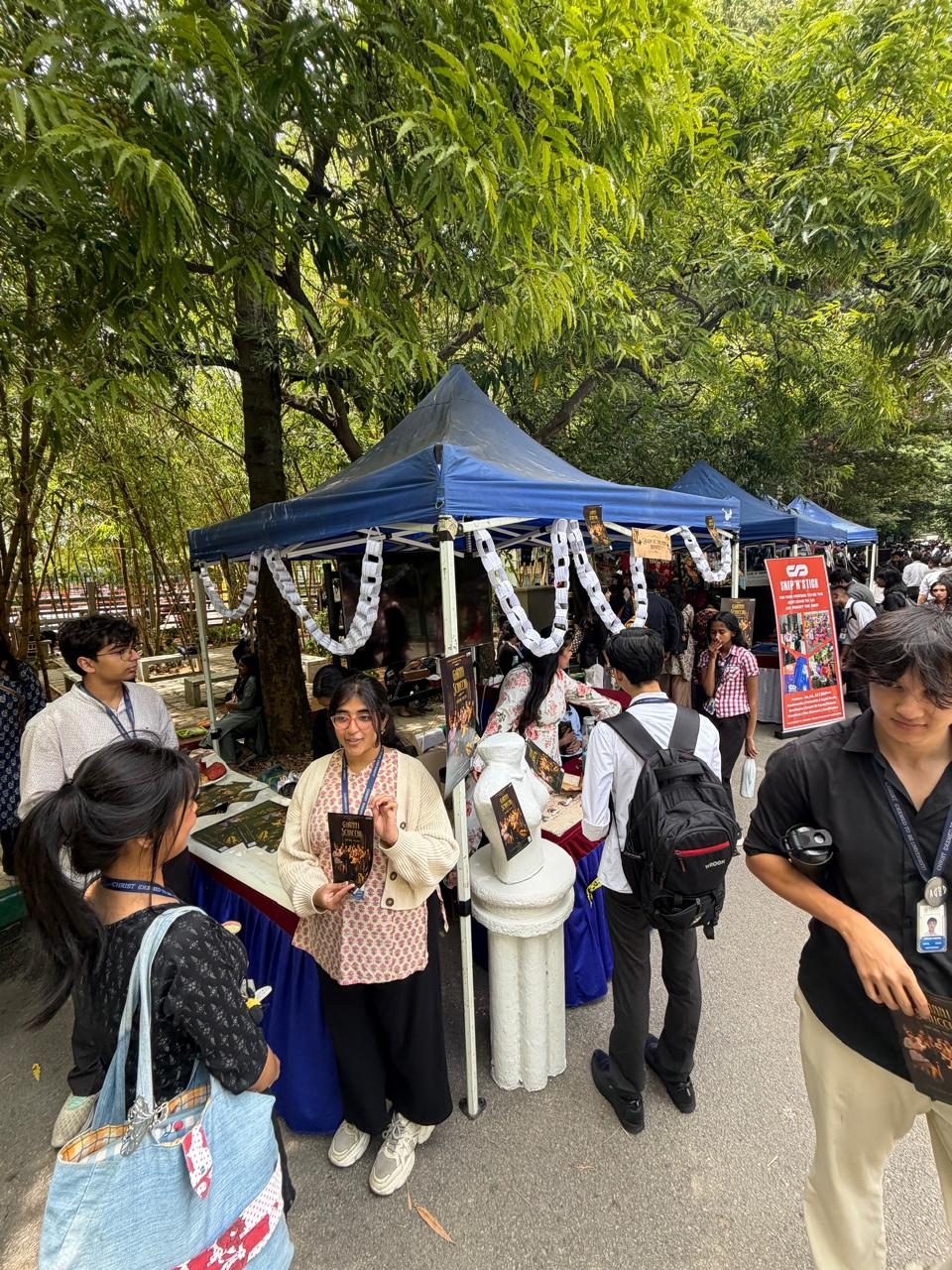 Students with backpacks at the stand between classes.