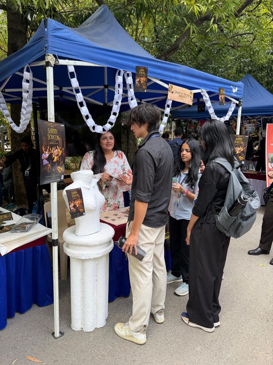 Visitors looking through photographs of the production at the stand.